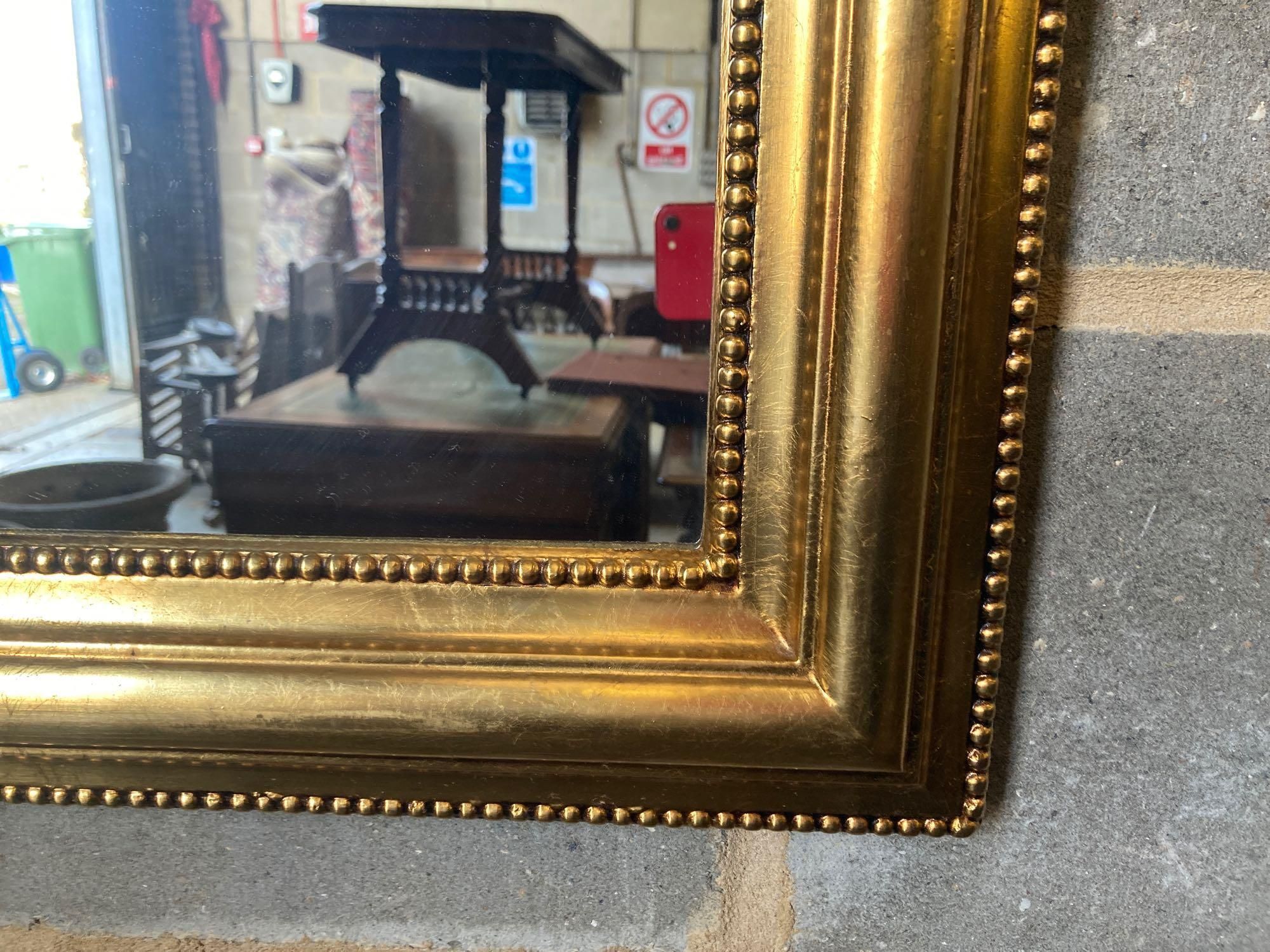 A modern gilt frame arched wall mirror, width 80cm height 100cm